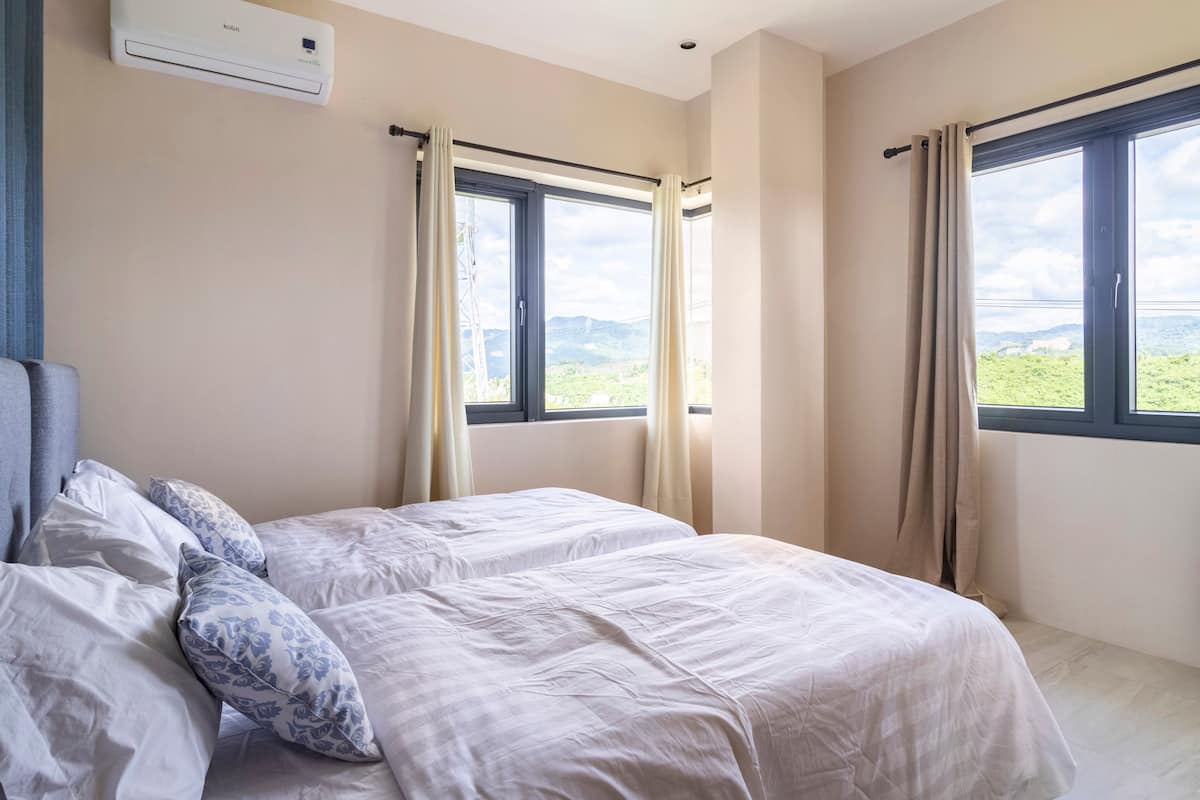 Bedroom four with twin beds and mountain views